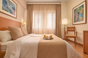 Postel nebo postele na pokoji v ubytování Athos Hotel