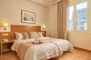 Postel nebo postele na pokoji v ubytování Athos Hotel