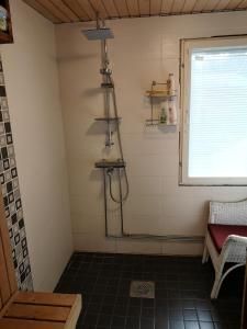 a shower in a small room with a window at Kouvola Guest house in Kouvola