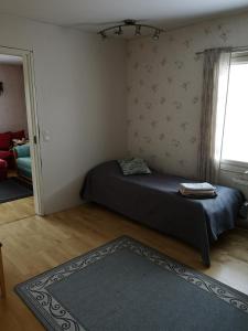 1 dormitorio con cama, ventana y alfombra en Kouvola Guest house en Kouvola
