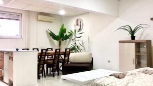 a living room with a kitchen and a dining room at Apartment on a river avenue in Pančevo