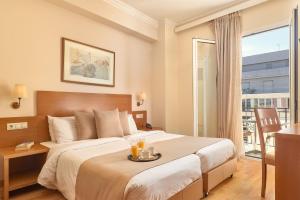 Postel nebo postele na pokoji v ubytování Athos Hotel