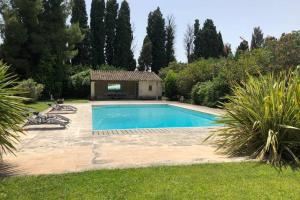 una piscina en un patio con una casa en MAS SAINT GEORGES DE L'ORATOIRE, en Châteaurenard