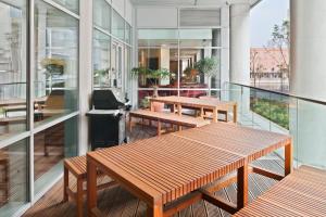 a balcony with benches and tables on a building at Staybridge Suites Liverpool, an IHG Hotel in Liverpool