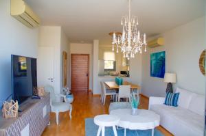 a living room with a couch and a chandelier at Atlantis Gardens in Mazotos