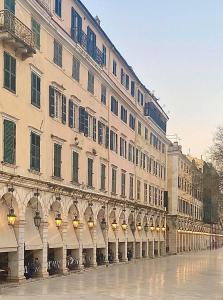 a large building with lights on the side of it at Ninos Luxury Apartment in Corfu Town
