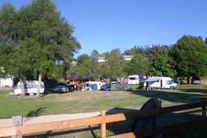 a group of tents and cars parked in a park at Camping Chez Prosper in Fournels