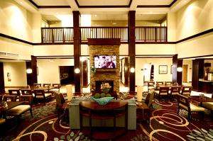 a living room filled with furniture and a large clock at Staybridge Suites Minot, an IHG Hotel in Minot