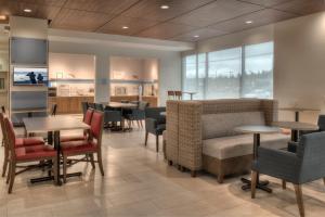 a dining room with tables and chairs and tablesktop at Holiday Inn Express & Suites Victoria-Colwood by IHG in Victoria