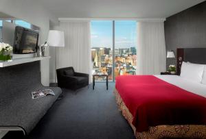 a hotel room with a red bed and a window at Radisson Blu Hotel, Bristol in Bristol