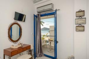 
a bathroom with a mirror and a sink at Saint George Hotel in Naxos Chora
