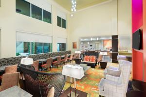 マイアミにあるStaybridge Suites - Miami International Airport by IHGのホテルのロビー(椅子、テーブル付)
