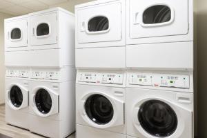 four washers and dryers stacked in a laundry room at Staybridge Suites - Miami International Airport by IHG in Miami