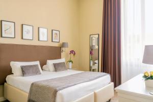 a hotel room with a bed and a window at Dedo Boutique Hotel in Florence