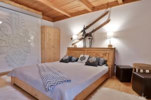 a bedroom with a large bed with a wooden headboard at Willa na Równi in Zakopane
