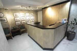 a lobby with a counter in a room with chairs at Barrack Street Hotel in Taiping