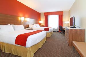 a hotel room with two beds and two lamps at Holiday Inn Express and Suites Calgary University, an IHG Hotel in Calgary