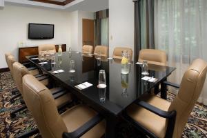 a conference room with a long table and chairs at Staybridge Suites North Brunswick by IHG in North Brunswick +58 photos