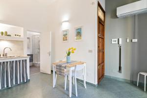 a kitchen and dining room with a table and chairs at Stylish Flat Maqueda in Palermo