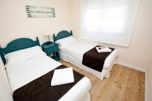 Posteľ alebo postele v izbe v ubytovaní Apartamentos Golf Place + 37 fotografií
