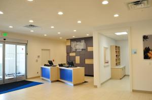 an office with a desk with a computer on a wall at Holiday Inn Express & Suites Price by IHG in Price +30 photos