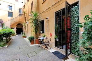 a courtyard with a table and chairs next to a building at Relax Chiavari House in Rome
