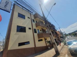 a building with a pole next to a street at Hotel Meyer in Francisco Beltrão