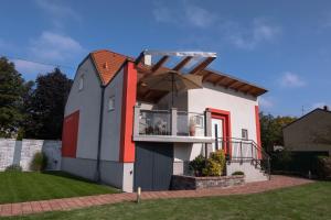 a house shaped like a church with an umbrella at Ferienhaus Koch in Mönchhof