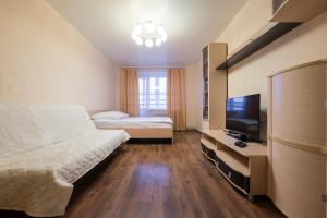 a hotel room with a bed and a television at OK! Советская, 69 №1 in Tomsk