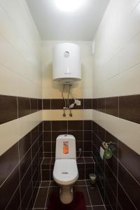 a bathroom with a toilet with a white tank at OK! Советская, 69 №1 in Tomsk