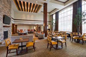 a restaurant with tables and chairs and a fireplace at Staybridge Suites Montgomeryville, an IHG Hotel in North Wales