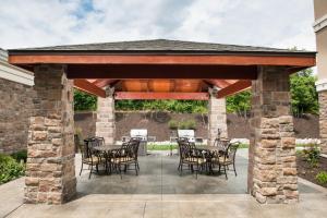 a wooden pavilion with tables and chairs on a patio at Staybridge Suites Montgomeryville, an IHG Hotel in North Wales