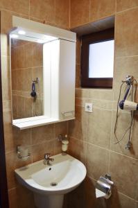 a bathroom with a sink and a mirror at Vila Andrei in Băile Olăneşti +36 photos