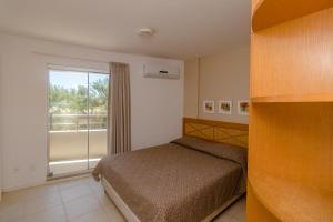 Un ou plusieurs lits dans un hébergement de l'établissement Residence Vespucci Flat Beira Mar