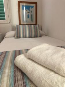 two beds with pillows on them in a bedroom at Solmar Menorcacom in Cala en Bosc