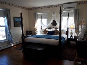 a bedroom with a large bed with a canopy at Hillside Landing B&B in Digby
