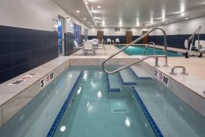 a swimming pool in a hotel room with a pool at Staybridge Suites Rapid City - Rushmore, an IHG Hotel in Rapid City