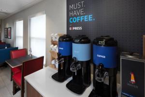 a coffee shop with a row of espresso machines on a counter at Holiday Inn Express Middlesboro by IHG in Middlesboro