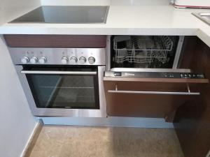 a kitchen with an oven and a microwave at Apartament Vistamar in Llança