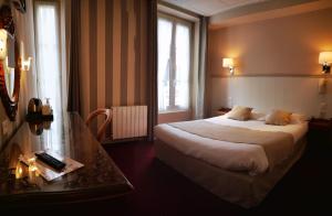 מיטה או מיטות בחדר ב-Hotel des Abers