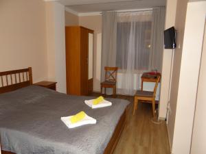 a bedroom with a bed and a desk at Pension Europa in Prague