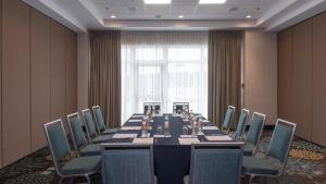 a conference room with a long table and chairs at Staybridge Suites Puebla by IHG in Puebla +65 photos