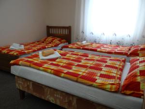 two beds in a room with a white bedspread at Pension Europa in Prague