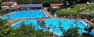 a large swimming pool with many people in it at Evangelische Tagungsstätte Bad Boll in Göppingen