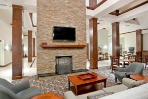 a living room with a fireplace and a tv at Staybridge Suites Everett - Paine Field, an IHG Hotel in Mukilteo