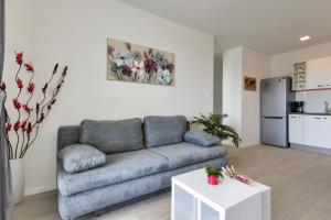 a living room with a couch and a table at My Apartment in Zadar