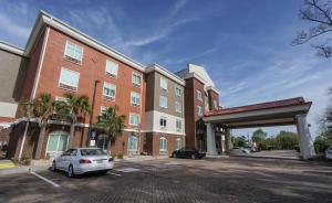 a parking lot in front of a large brick building at Holiday Inn Express Hotel & Suites Savannah Midtown, an IHG Hotel in Savannah