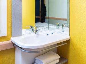 a bathroom with a sink and a mirror at ibis budget Paris Porte de Vincennes in Paris