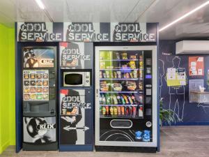 a store with two vending machines in a room at ibis budget Lyon Est Chaponnay in Chaponnay