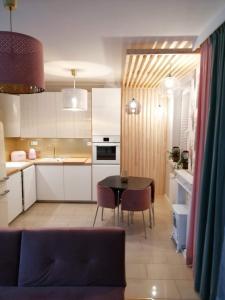 a kitchen with a table and a dining room at Apartament w trójmiescie in Kowale